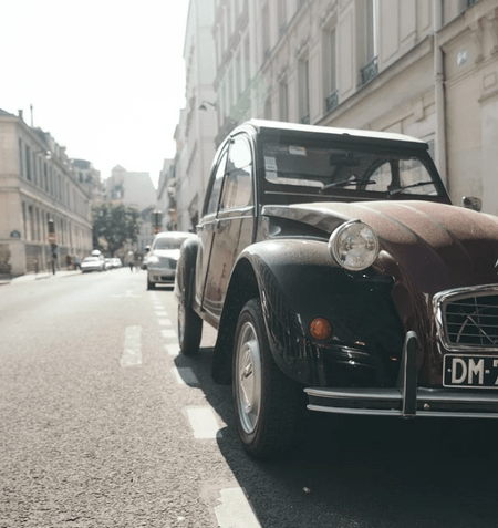 Old Citroen 2CV parking on the street.